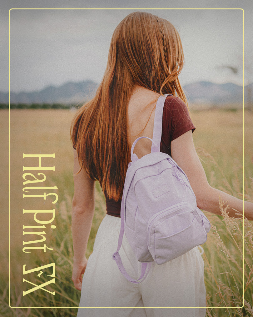 Person with a jansport backpack walking through a field with 'Half Pint FX' text overlay